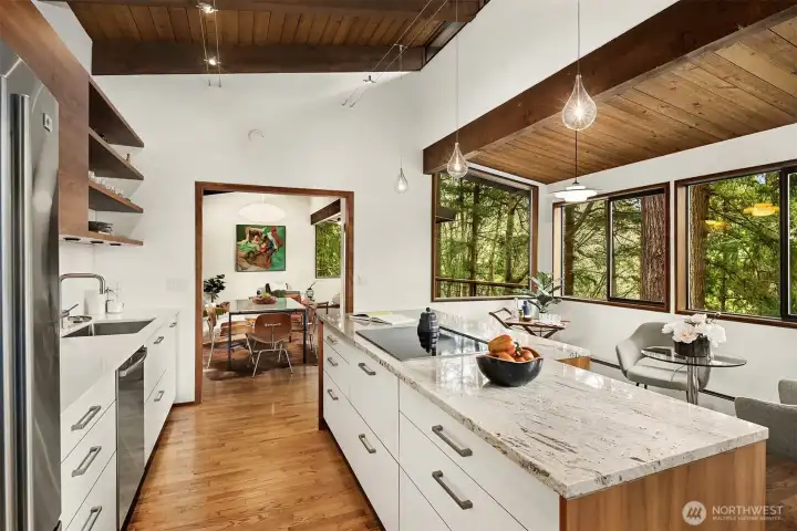 Mirroring the bump-out in the living room, this space in the kitchen offers additional seating, and perhaps a fun bar cart as we're showing here.  The window looks across the deck into the living room, for a lovely sense of connectivity to that space.
