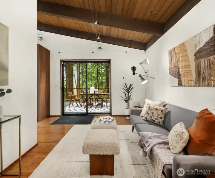 A slider connects the kitchen and flex space to the large side deck.