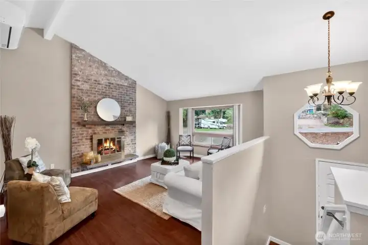 Step inside to vaulted ceilings, bamboo hardwood floors and abundant natural light from solar tubes.  Light and bright living room features cozy fireplace