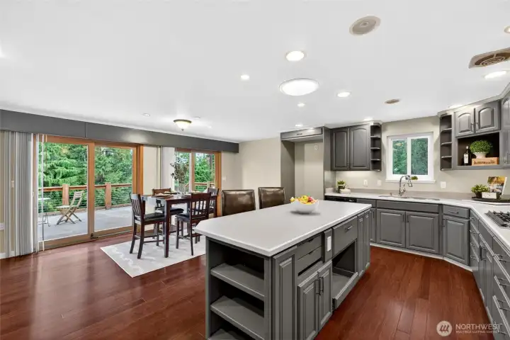 Large kitchen offers lots of cabinets and brand new appliances including gas range.  Dining area with sliders to deck and greenbelt views