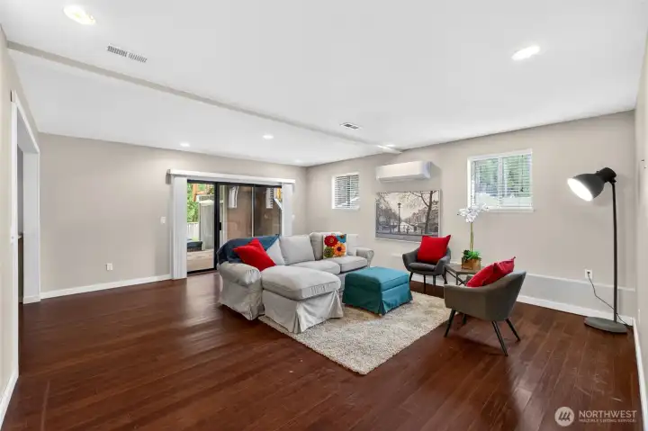 Downstairs offers bonus room for extended living and entertaining
