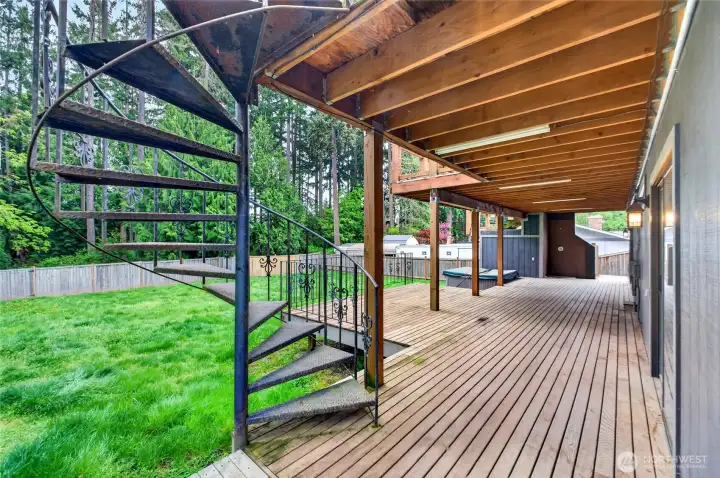Covered lower deck offers more entertaining space with hot tub, outdoor shower that can be brought back to life and slider to bonus room