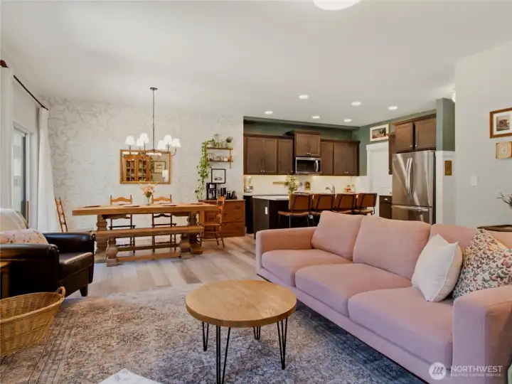 Open concept living with spacious dining room and large chef's kitchen with island and walk-in pantry.