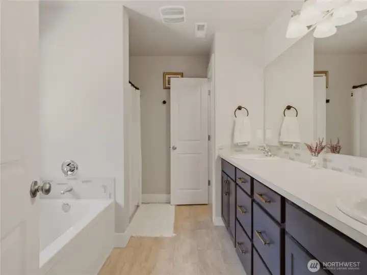 Bright five-piece primary bathroom.