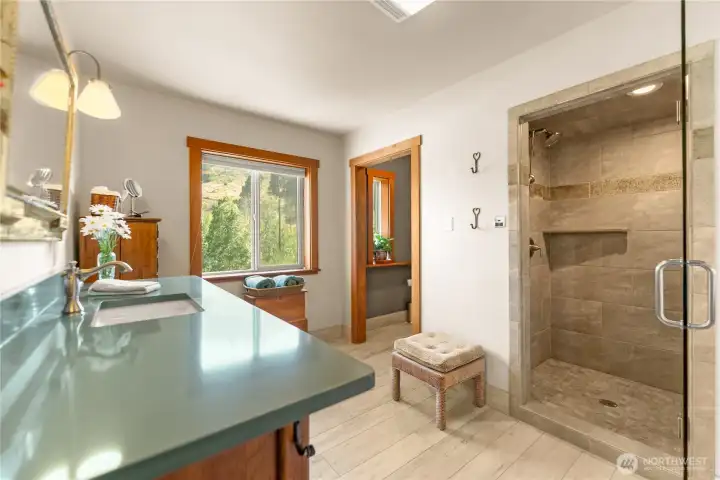 The remodeled primary bath offers a spa-like retreat featuring radiant heated tile floors, a spacious steam shower and quality finishes designed for everyday comfort. The remodeled primary bath offers a spa-like retreat featuring radiant heated tile floors, a spacious steam shower and quality finishes designed for everyday comfort.