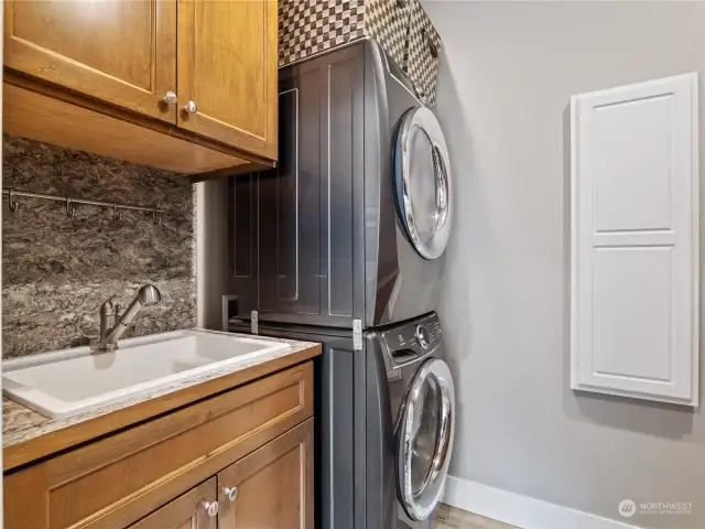 Nice laundry room includes cabinets and countertop on other side.
