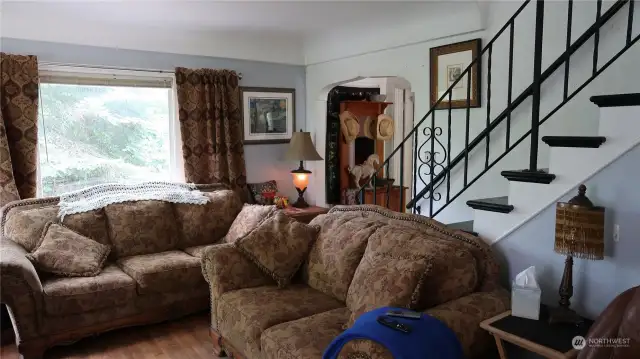 Front room with stares going up stairs and notice the arches all though the home