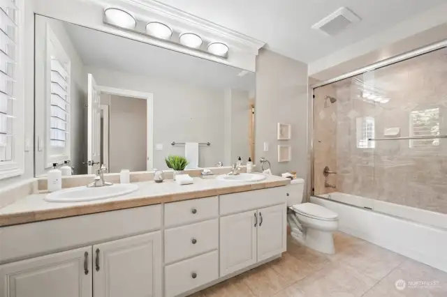 Just off the upstairs bedrooms is this spacious, well-appointed hall bath with dual sinks, tub and shower.