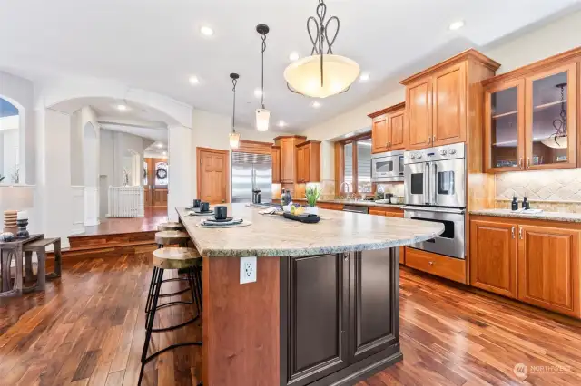 Marvelous built-ins, stunning lighting, timeless wood finishes, and incredible satin-finish granite round out this lovely kitchen.