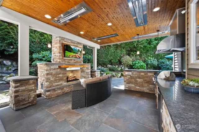 Love to barbeque? Invite friends out the patio door to this stunning outdoor kitchen retreat! TV and custom couch stay with the home.
