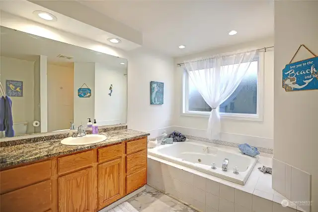 Full walk in tiled shower with soaking tub on main floor