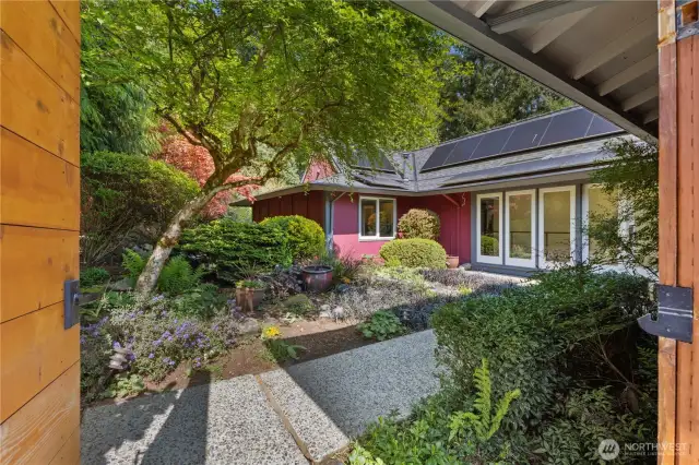 Enter the home with a beautifully landscaped pond area