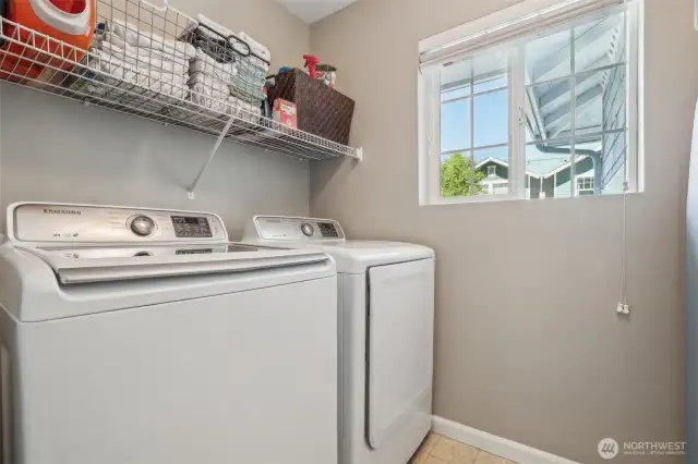 Upper floor laundry room with a closet