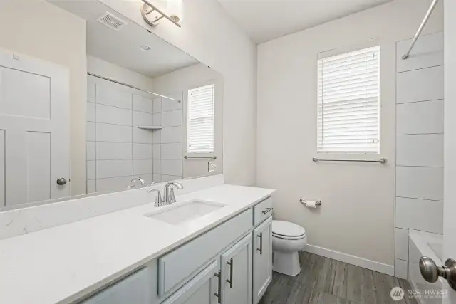 Full Guest Bath with Quartz Slab Vanity Conveniently Located Between Both Guest Bdrms!
