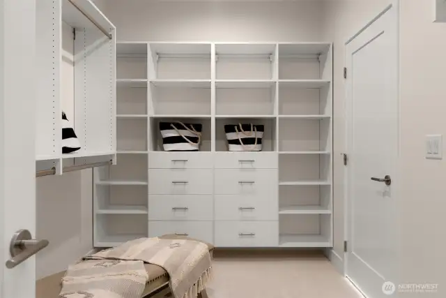 A dream walk-in closet featuring custom shelving, ample storage, and boutique-inspired design.