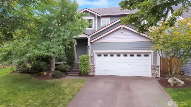 Front view of home, mature landscaping just refreshed.