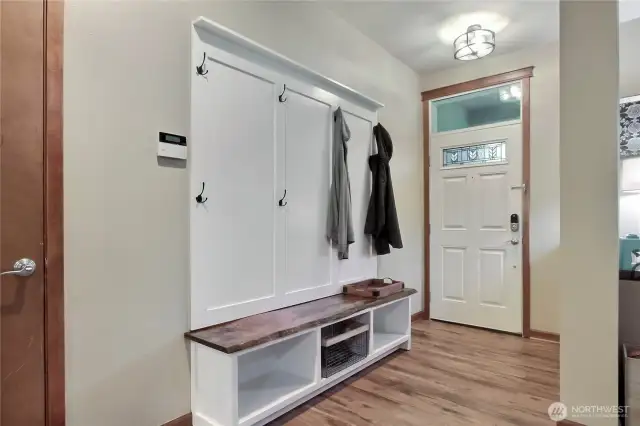 As you enter, you will find gorgeous flooring throughout this home, and I love this bench/cubby/coat hanger!