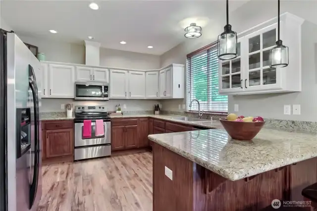 Kitchen view one, you will love the matching stainless steel appliances, contrasting white and brown cabinetry, andthe spacious granite countertops. Just beautiful.