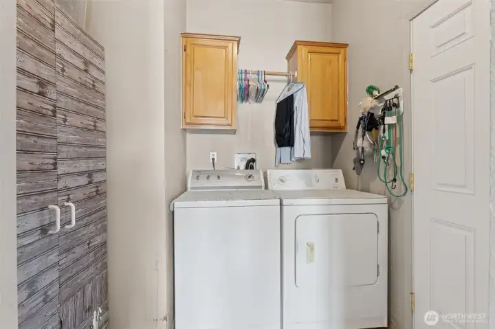 Utility room off of the kitchen with extra storage. Door to the right leads to the covered back porch