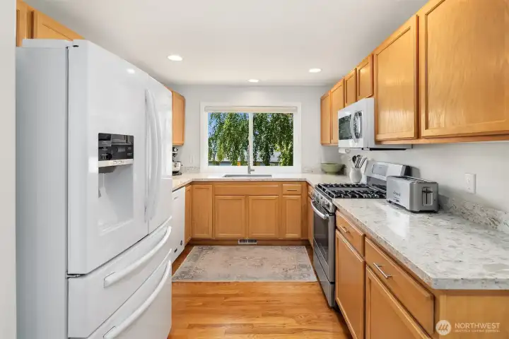 Kitchen with new quartz counter tops, sink, faucet, soft close hinges.