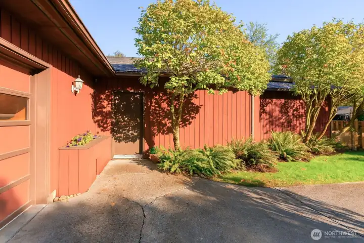 External front entry with planter box to the left.