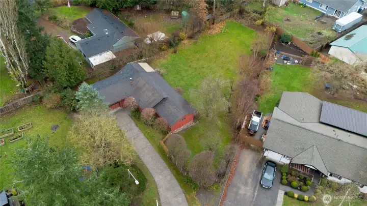Drone shot of the home and yard.  Neighborhodd as a small community park and mailbox cluster you will see as you drive into the home.