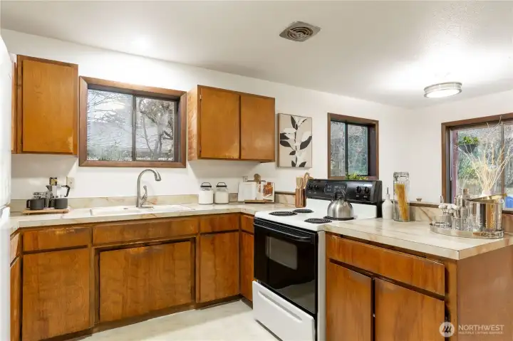 To the left of the kitchen area is the entry into the garage.  Also not shown is a larger sliding doors enclosed pantry with a lot of shelving.