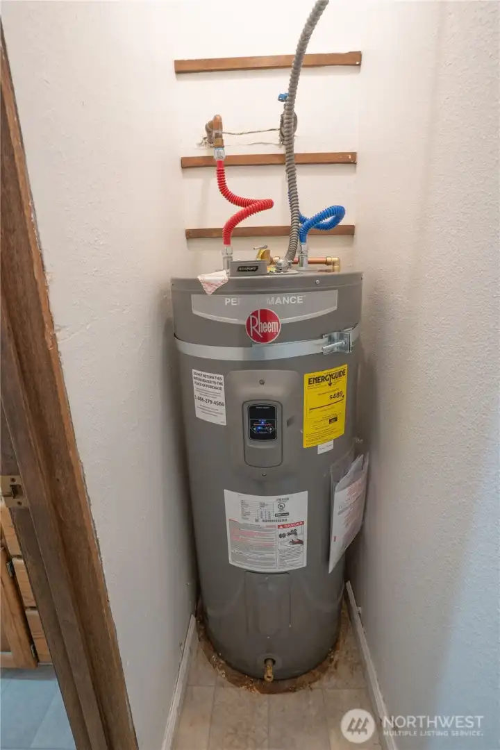 Small storage closet off of the bathroom also contains the hot water tank new 2025,