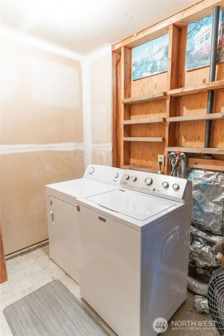 Washer and dryer.  Has two walls and ceiling ready to be textured and painted. Doorway from home could be added to make more accessible and part of the home SF.