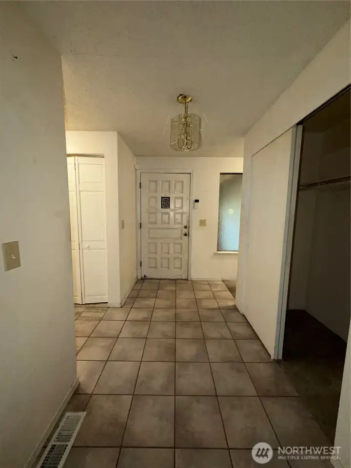 View of the entry way from the living room. Laundry area is to the left.