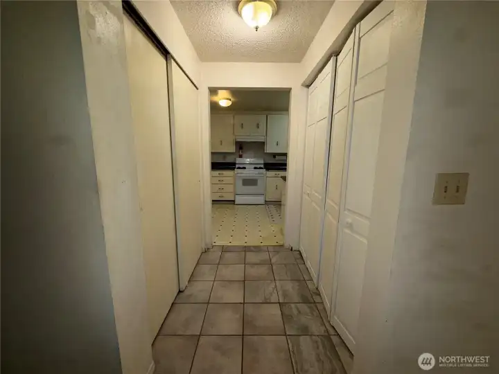 As you enter to the right, a hall to the kitchen with laundry on the right and pantry on the left.