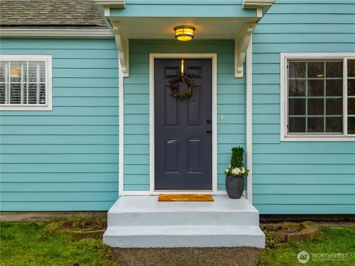 This freshly painted porch and front door invites you in.