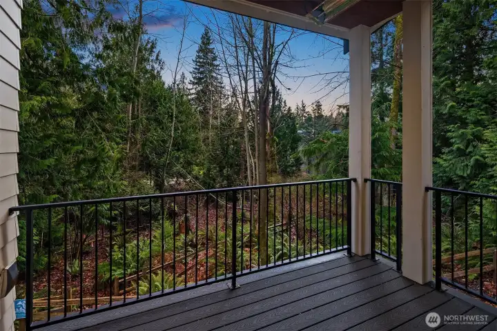 Off the covered deck are lush green views of serene nature. Don't miss the heater hanging above to keep you comfortable on chilly nights.