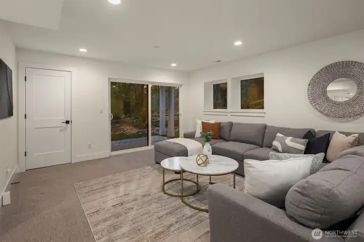 The lower level is a daylight basement, generous in space, flexing a large rec room with a walk-out covered outdoor space to enjoy.