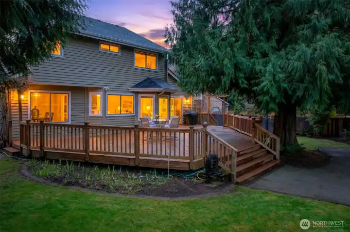 Twilight ambiance highlights the home’s warm interior glow and the inviting deck, an ideal setting for evening dining, relaxing, and entertaining.