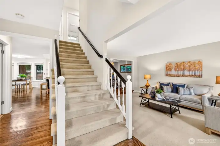 A bright entry with open sightlines creates an inviting feel the moment you step inside. Hardwood floors guide you toward the main gathering spaces and the upstairs bedrooms.