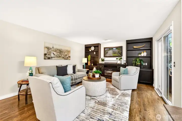 The family room is designed for comfort and connection, featuring an electric fireplace framed by custom built-ins. Large sliding glass doors open to the deck, creating an easy indoor to outdoor lifestyle.