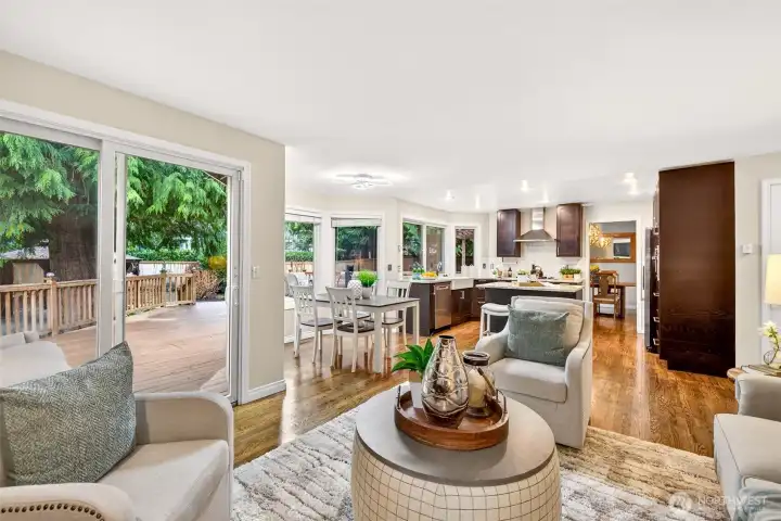 The main level opens up beautifully, connecting the kitchen, dining nook, and family room in one seamless layout. With sliding glass doors leading to the deck and multiple windows, natural light and outdoor access are always part of the experience.