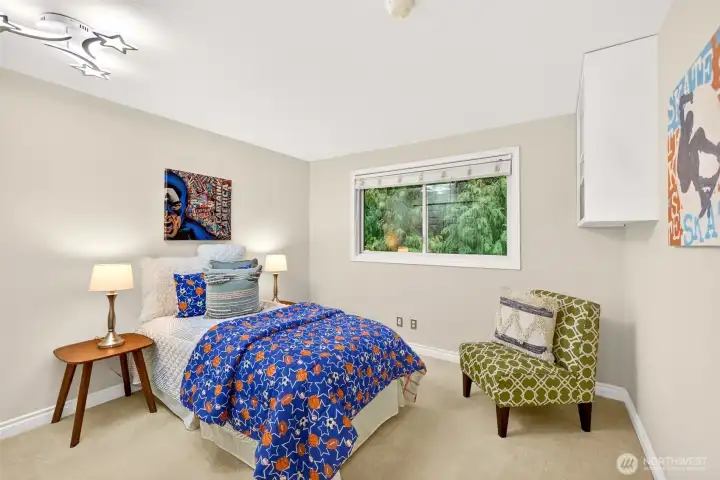 One of the secondary bedrooms offers a fun, memorable space with a wide window that brings in natural light. The room layout is versatile, ready to adapt for guests, hobbies, or a dedicated work from home setup.