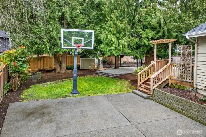Large sport court adds standout versatility for recreation, training, and play, with generous surrounding yard space and mature landscaping.