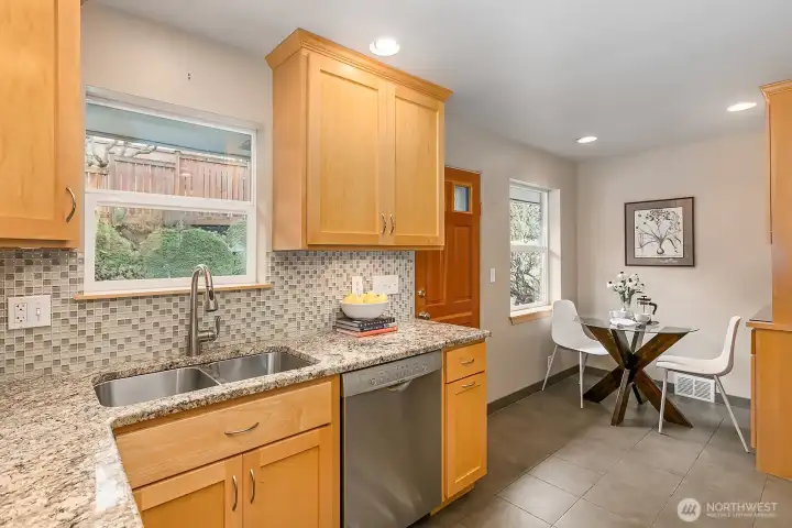 Another view showing the large window above the sink with views of the professionally designed patio, garden and yard.  Lots of birds to watch back there too!