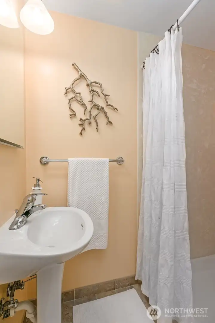 The lower level bath has an updated shower + tile floors