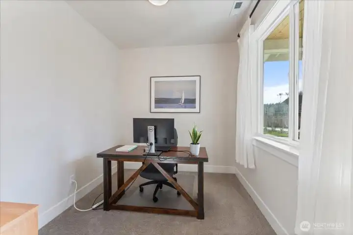 Main-level office/den is perfect for today's work-from-home lifestyle.