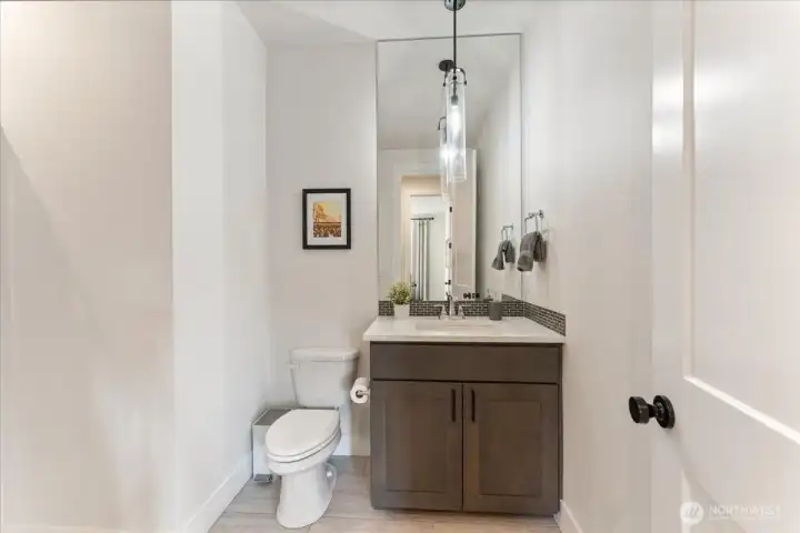 Main level guest bath thoughtfully placed across from the main level bedroom and den, creating a private, convenient guest experience.