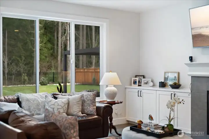 A family room adjacent to the kitchen with convenient built-ins perfect for displaying all your family photos and  storing your family games and puzzles.