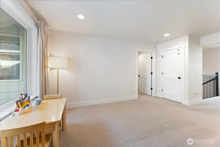 Another perspective of the loft, emphasizing the adaptable space for family and activities.