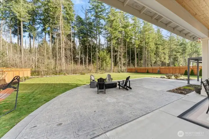 Seller has enhanced the outdoor living area with a beautifully stamped concrete patio spanning the full width of the home creating an elegant space for entertaining.