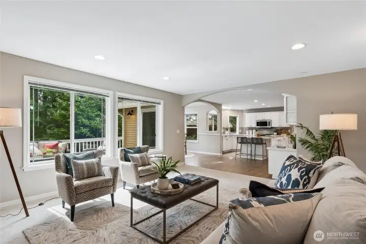 The family room adjoins the kitchen and breakfast nook, offering an open and integrated layout that blends comfort with effortless style.