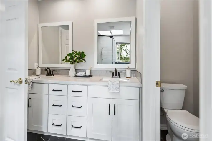 The luxurious five-piece, spa-inspired bath features dual vanities with new cabinets, sins, faucets, countertops and tile backsplash. The water closet has a new toilet too. The heated tile floors offers warm year round comfort.
