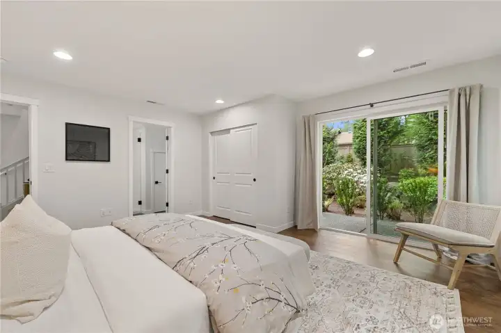 Spacious bedroom on the main floor with its own ensuite full bathroom and private covered patio to the backyard